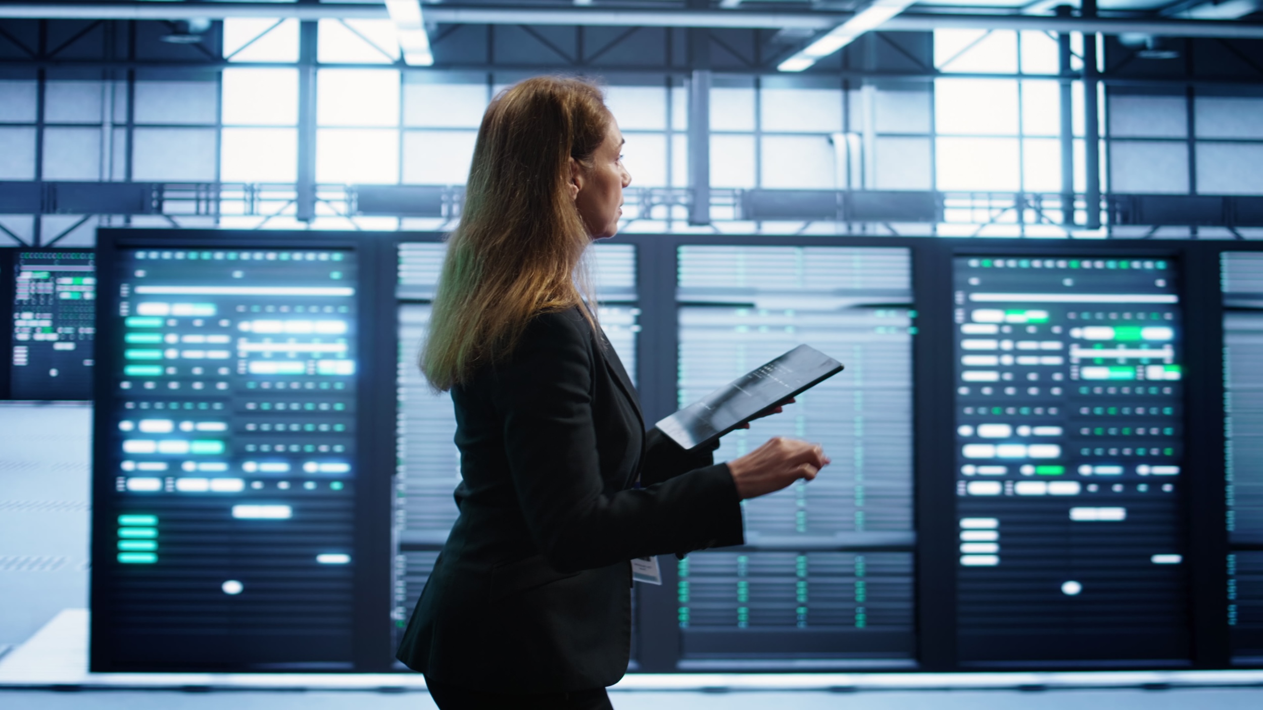 Woman in data center making sure rigs are functioning optimally